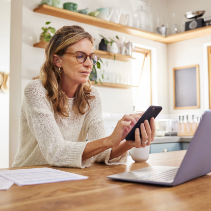 Woman scrolling on phone in a well lit room